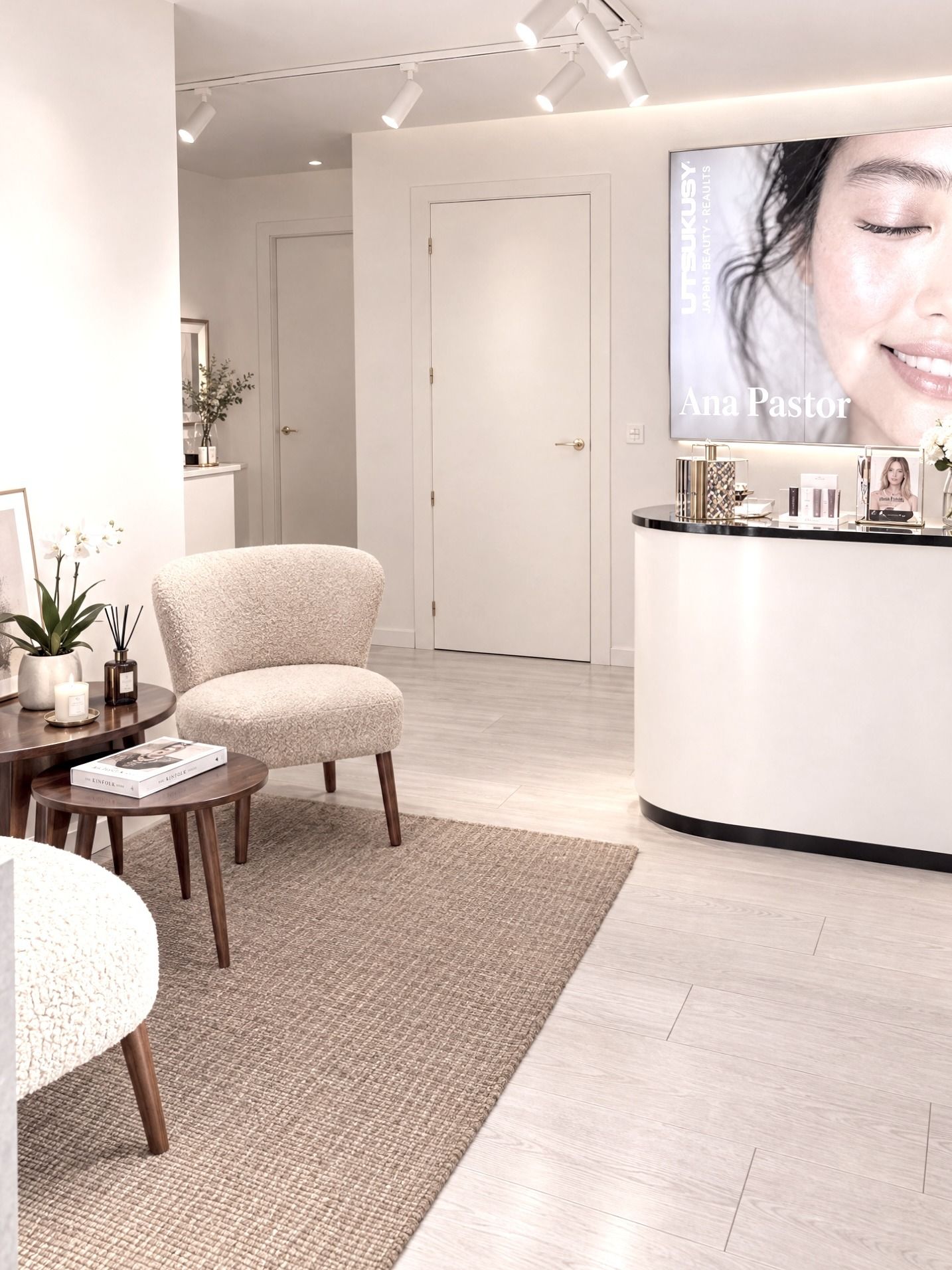 Recepción del centro Estética Ana Pastor en Palencia: butacas tapizadas, mesa de madera y mostrador con cosmética Utsukusy